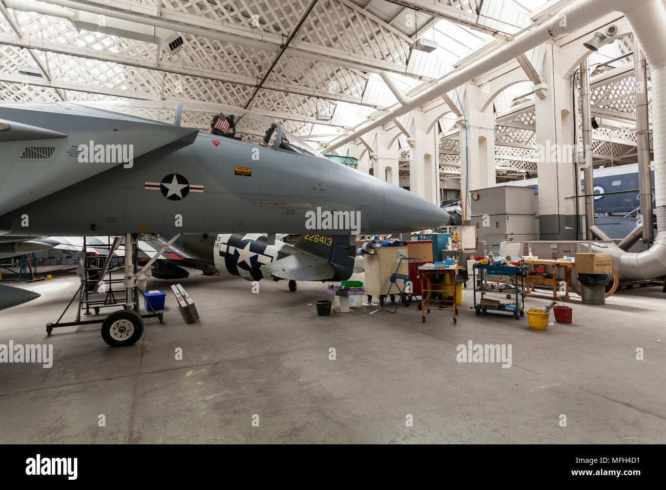 Duxford Air Museum. England, UK.  Several aircraft in the museum hanger's workshop for mainenance. Stock Photo