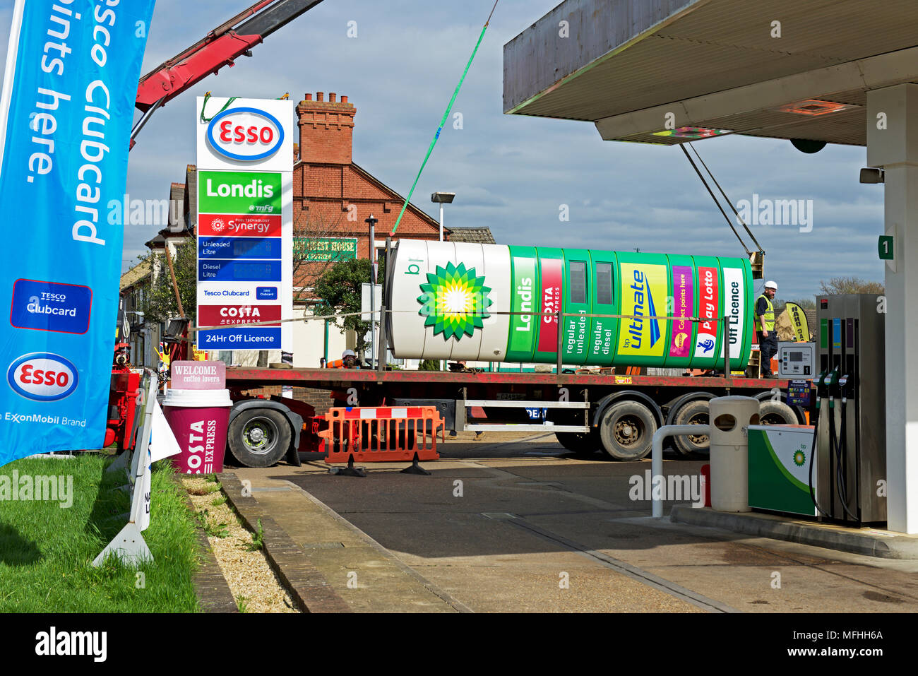 Replacing BP sign with Esso sign at a petrol station in Peterborough