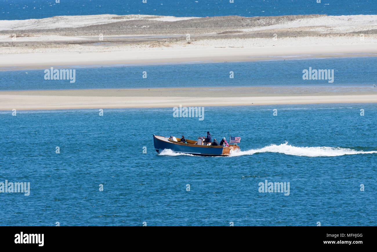 A motorboat makes it's way along Nauset Beach - a sandbar off Chatham, Massachusetts on Cape Cod, USA Stock Photo