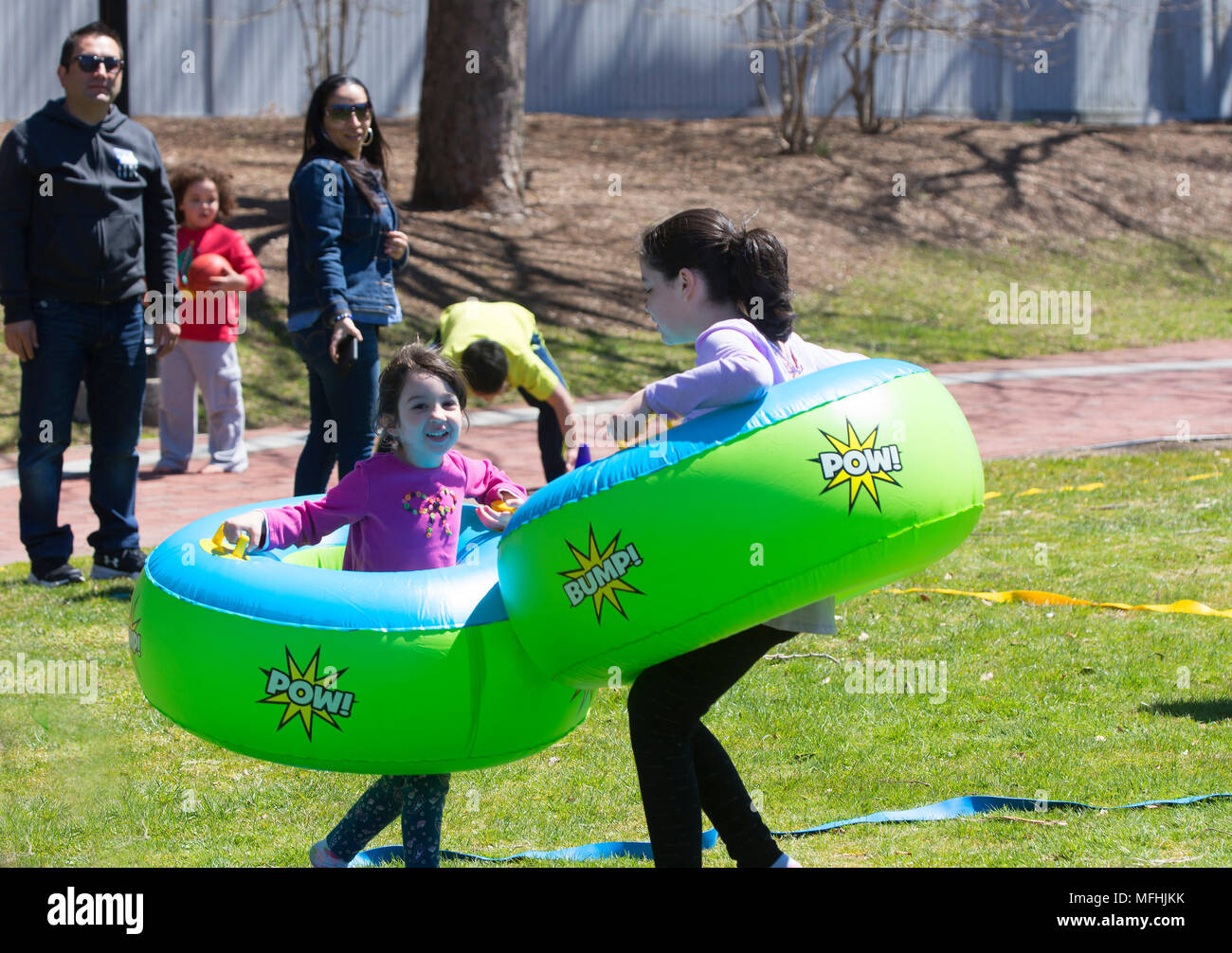 Two girls at play using bumper tubes at an Open Streets Festival in Hyannis, Massachusetts on Cape Cod, USA Stock Photo
