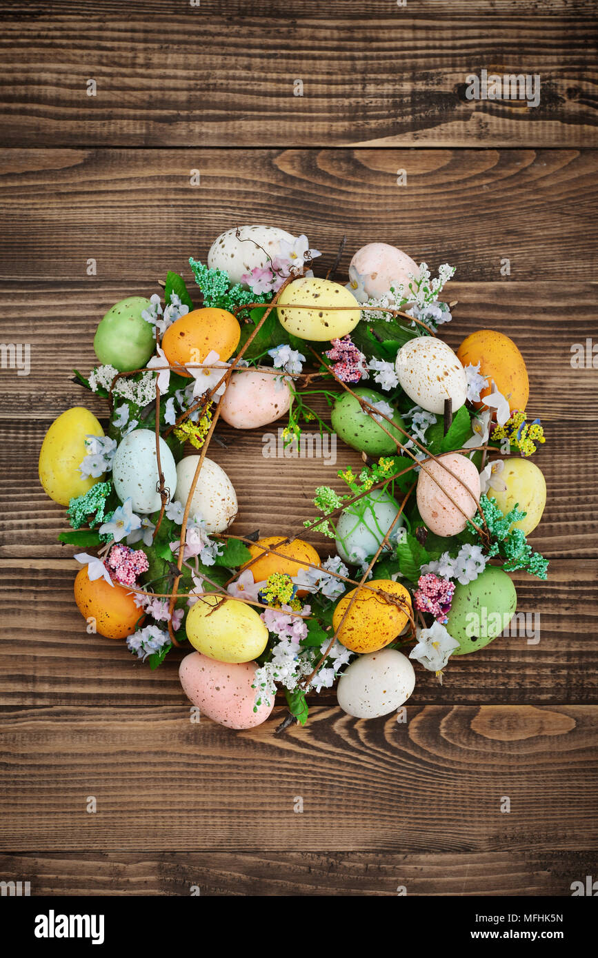 Decoration from easter eggs in shape of circle on painted wooden background Stock Photo