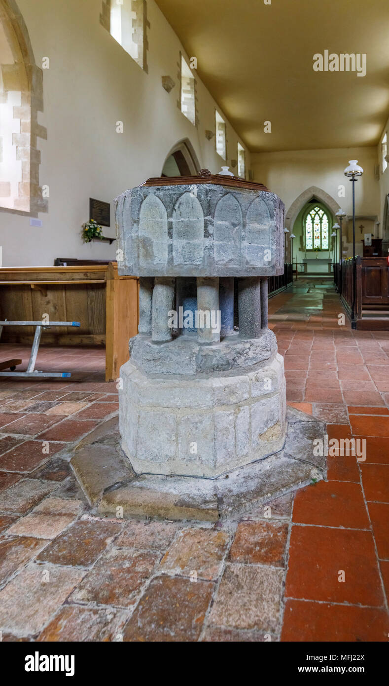 Traditional stone baptismal font and interior view of St Peter & St Paul church, Aston Rowant in
