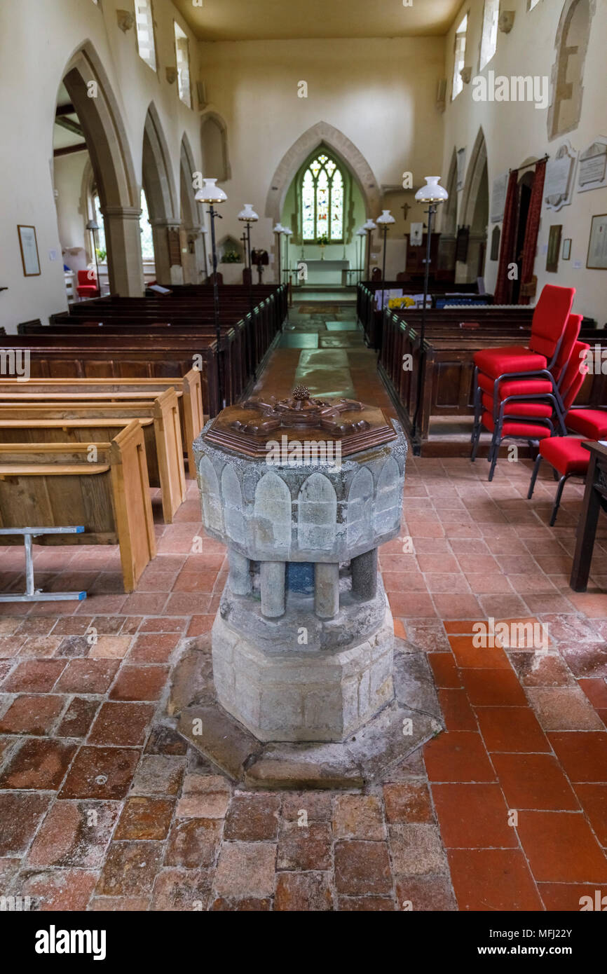Traditional stone baptismal font and interior view of St Peter & St Paul church, Aston Rowant in