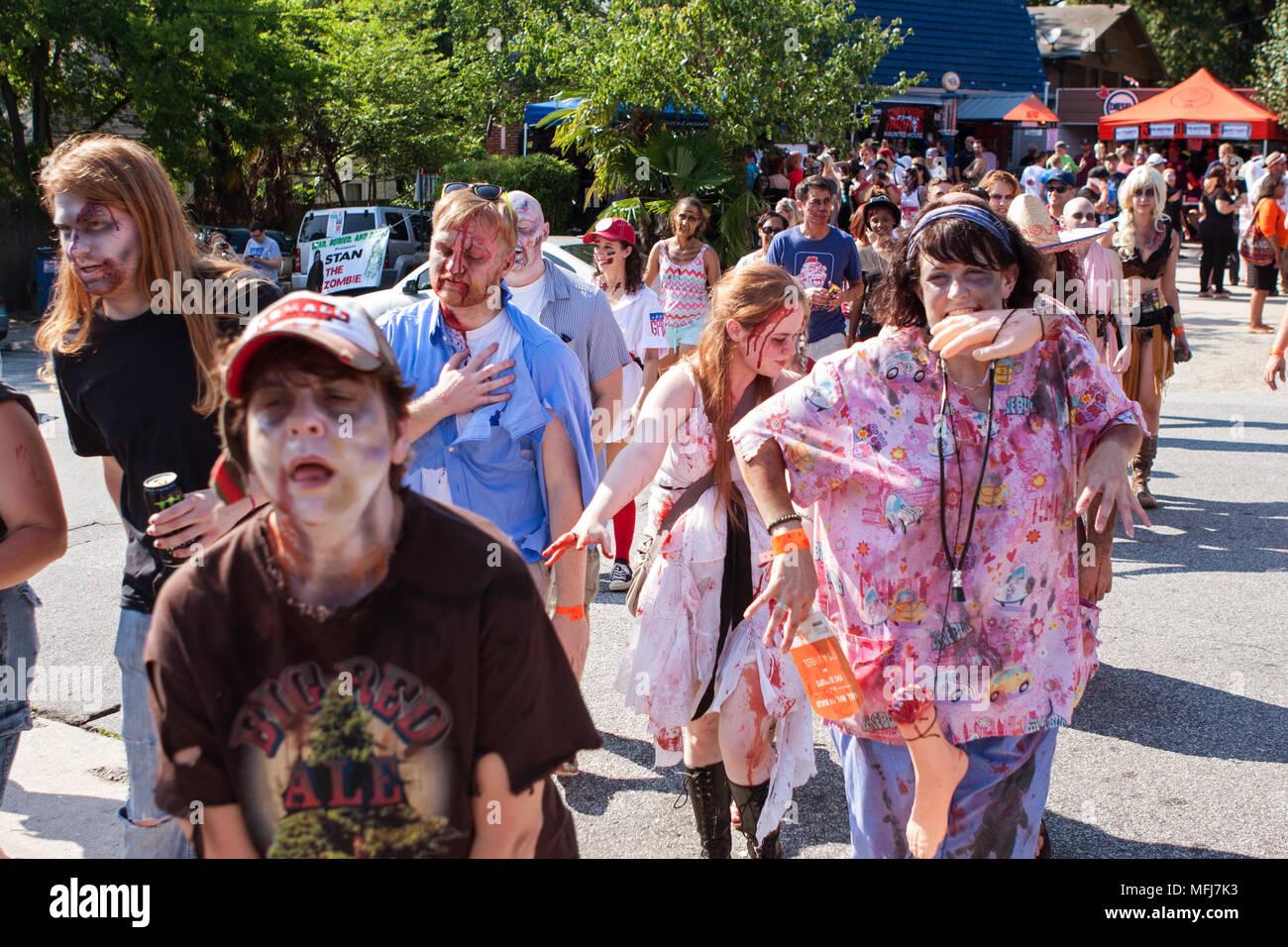A horde of bloody zombies stagger to nearby bars as part of the Atlanta Zombie Pub Crawl on July 25, 2015 in Atlanta, GA. Stock Photo