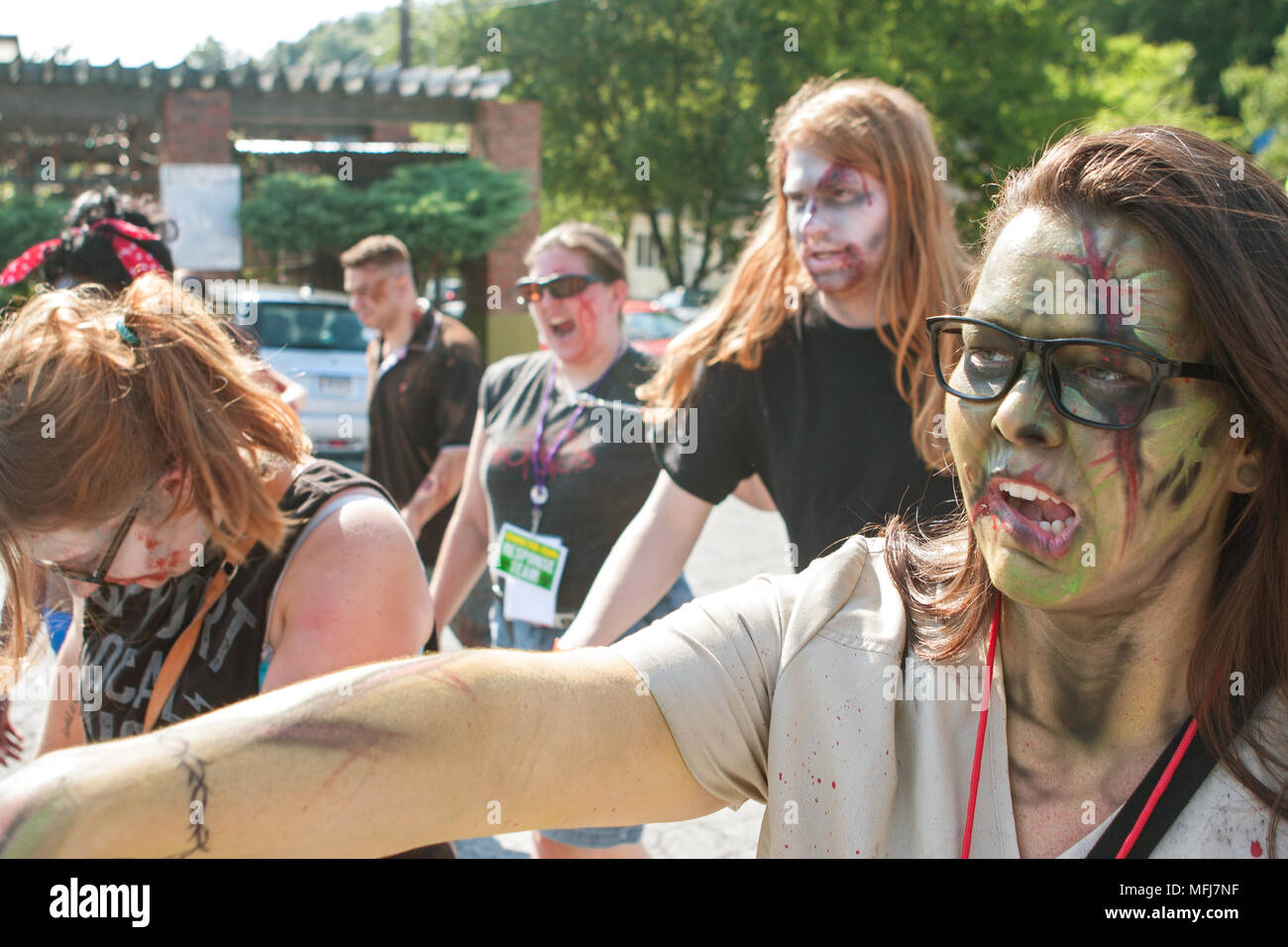 A horde of bloody zombies stagger to nearby bars as part of the Atlanta Zombie Pub Crawl on July 25, 2015 in Atlanta, GA. Stock Photo