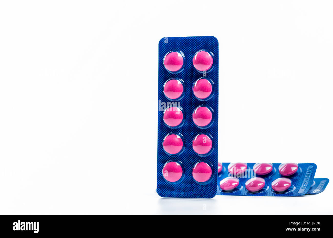 Ibuprofen in pink tablet pills pack in blue blister pack isolated on