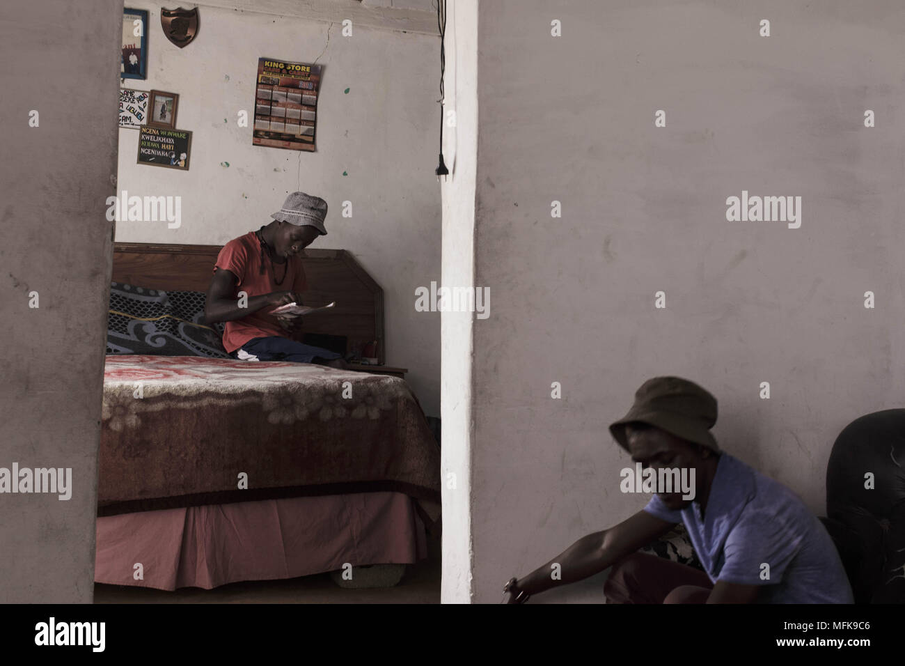January 12, 2018 - Matatiele, Eastern Cape, South Africa - Jake, 23, sits on his bed and smokes cannabis. He says: 'I have nothing to do all day. I have finished school, but for what? There are no jobs. I am bored, and if I stay at home all day I would become crazy. To keep myself busy I wake up in the morning, then go to town and push people's trollies outside the Spar supermarket. Then I come back home to the village and sell cannabis, and hang out with my friends. I want to find a job and do something meaningful with my life. But there is nothing. You have to be very lucky to find a job aro Stock Photo