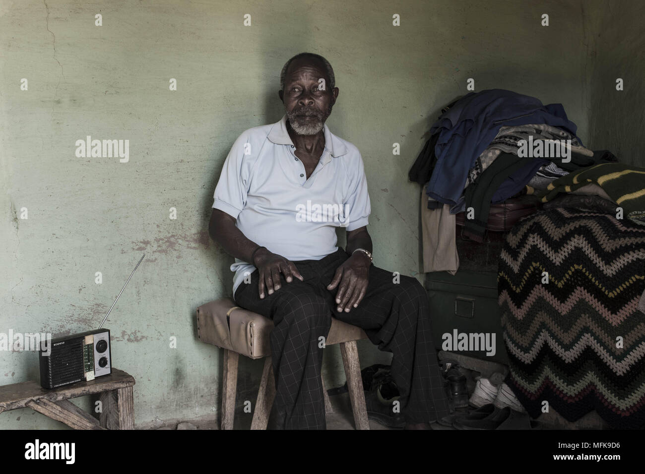 January 12, 2018 - Matatiele, Eastern Cape, South Africa - Thabo, 72, sits in his mud house and listens to the radio. He complains that there is nothing to do and that life is hard. The government has promised them all kinds of things, but has not delivered their promises..'We are not really living here. They have forgotten about us. (Credit Image: © Stefan Kleinowitz via ZUMA Wire) Stock Photo