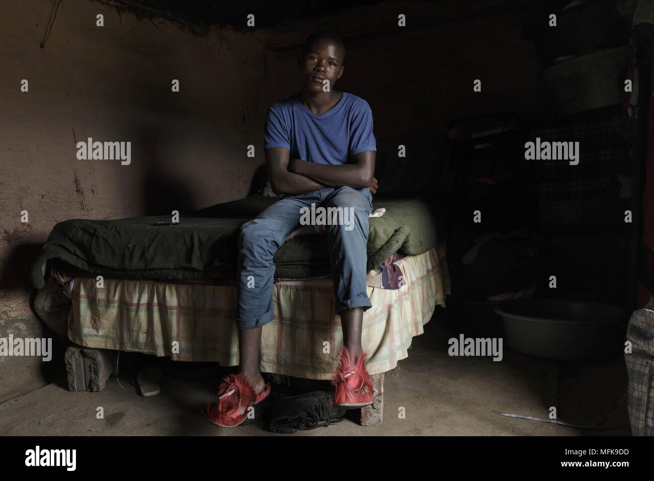 January 13, 2018 - Matatiele, Eastern Cape, South Africa - Thebo, 20, sits on his bed in his mud house. He dropped out of school and sells cannabis. He says: 'My friends who finished school are all without a job, or they have left to Johannesburg' (Credit Image: © Stefan Kleinowitz via ZUMA Wire) Stock Photo