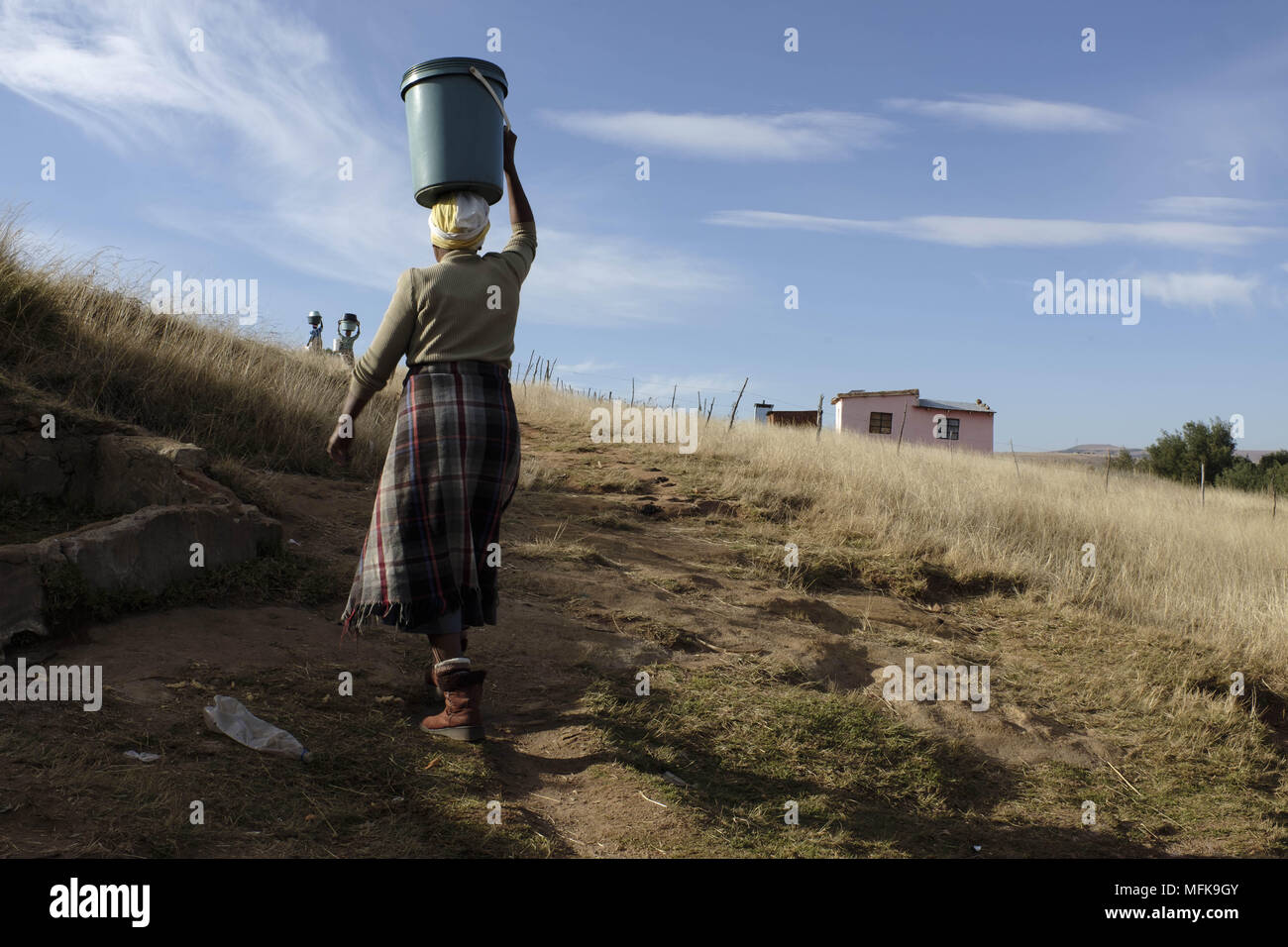 June 9, 2016 - Matatiele, Eastern Cape, South Africa - For a majority of people at the Eastern Cape it is a daily routine to carry buckets of spring water from the water source to their household. Running water, sanitation, and electricity have not reached small, and remote rural villages. (Credit Image: © Stefan Kleinowitz via ZUMA Wire) Stock Photo