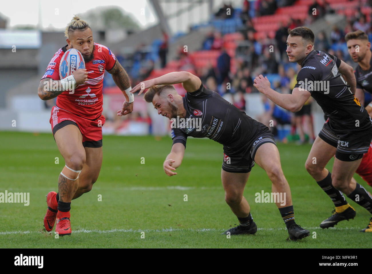 Manchester, UK. 26th April 2018 , AJ Bell Stadium, Manchester, England; Betfred Super League rugby, Round 13, Salford Red Devils v St Helens ; Junior Sa'u of Salford Red Devils breaks through the line Credit: News Images /Alamy Live News Stock Photo