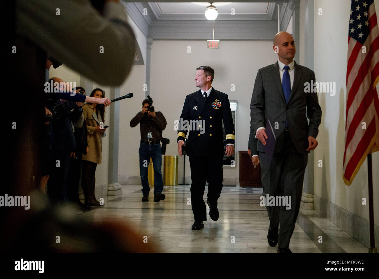 Washington, USA. 16th Apr, 2018. Veterans Affairs Secretary nominee Ronny Jackson (C) is seen on Capitol Hill in Washington, DC, the United States, on April 16, 2018. White House physician Ronny Jackson announced on April 26 that he had withdrawn from President Donald Trump's nomination to be the next Veterans Affairs Secretary, in the wake of a series of allegations that he had fostered a hostile work environment and behaved improperly while serving as the top doctor in the White House. Credit: Ting Shen/Xinhua/Alamy Live News Stock Photo