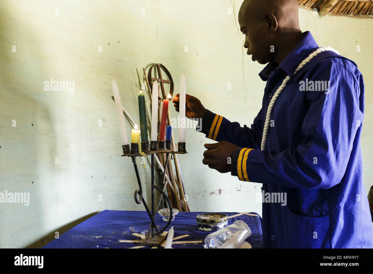 Matatiele, Eastern Cape, South Africa. 14th Jan, 2018. A priest is lighting the candles in a small church for the Sunday service. Credit: Stefan Kleinowitz/ZUMA Wire/Alamy Live News Stock Photo