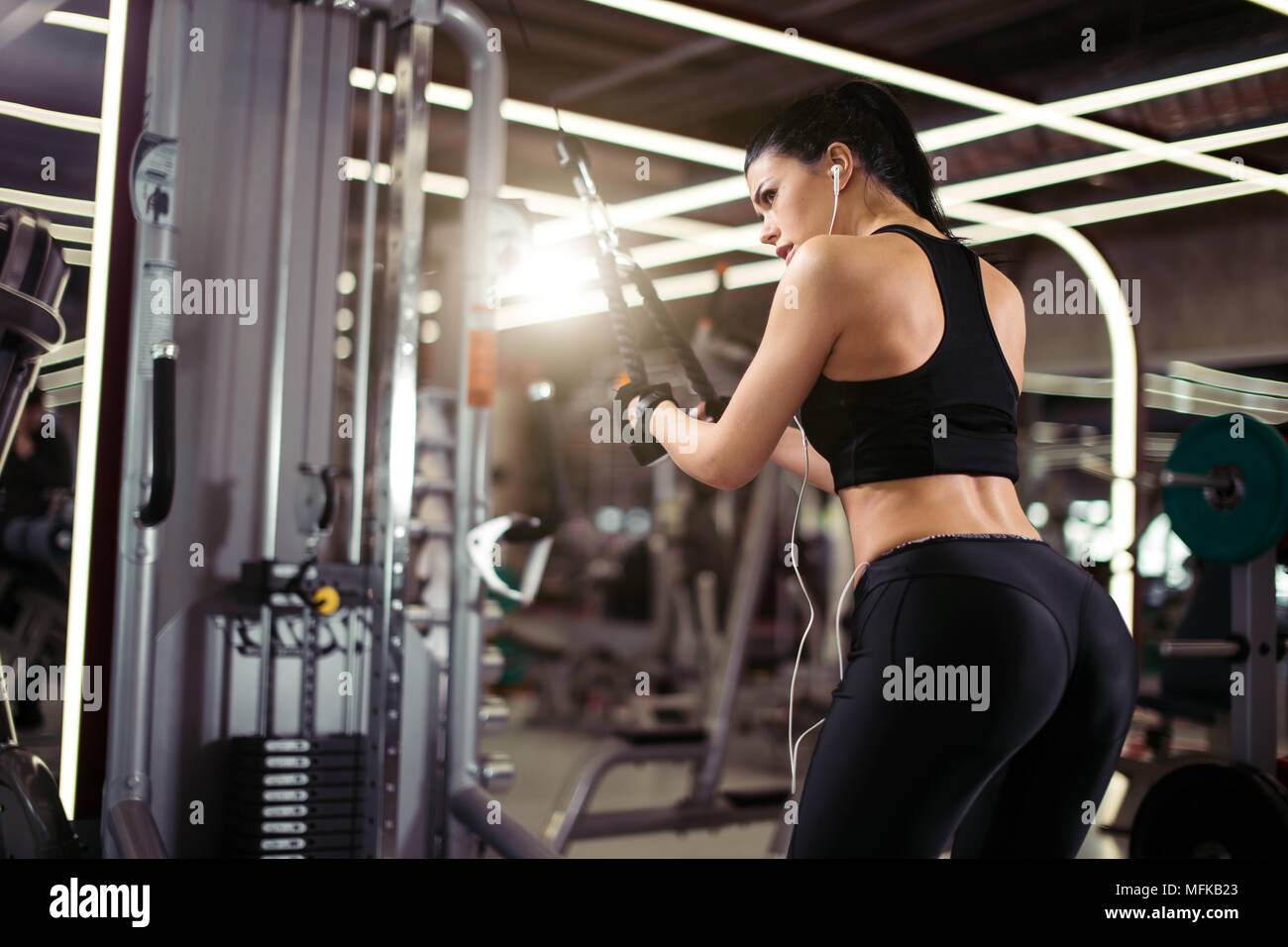 rear view of fit woman execute exercise with exercise machine Cable Crossover in gym Stock Photo Alamy