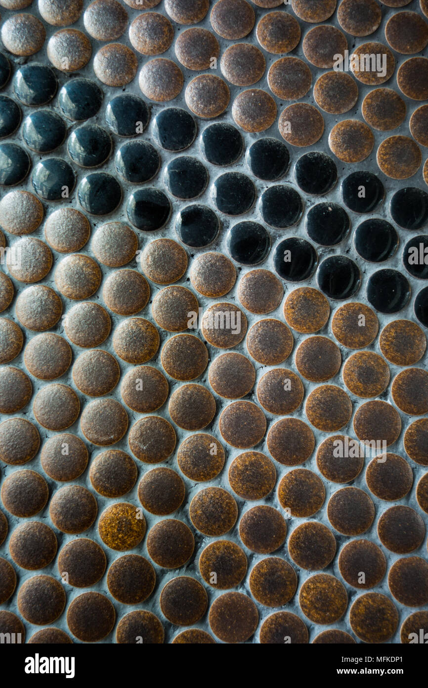 An interesting brown and black tile pattern on the side of a building Stock Photo
