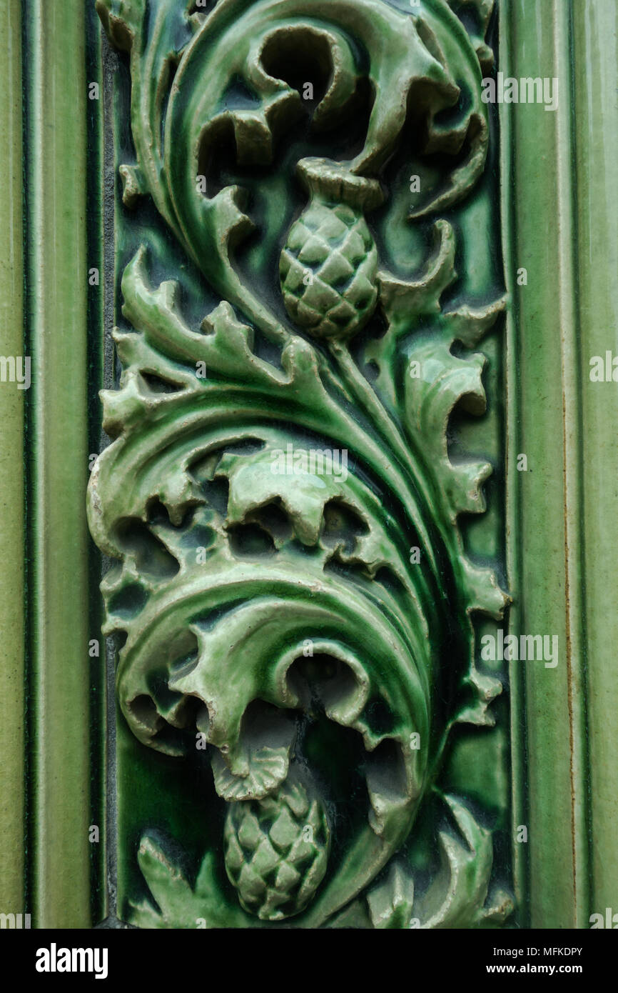 An ornate ceramic filigree adornment on the side of an old building Stock Photo