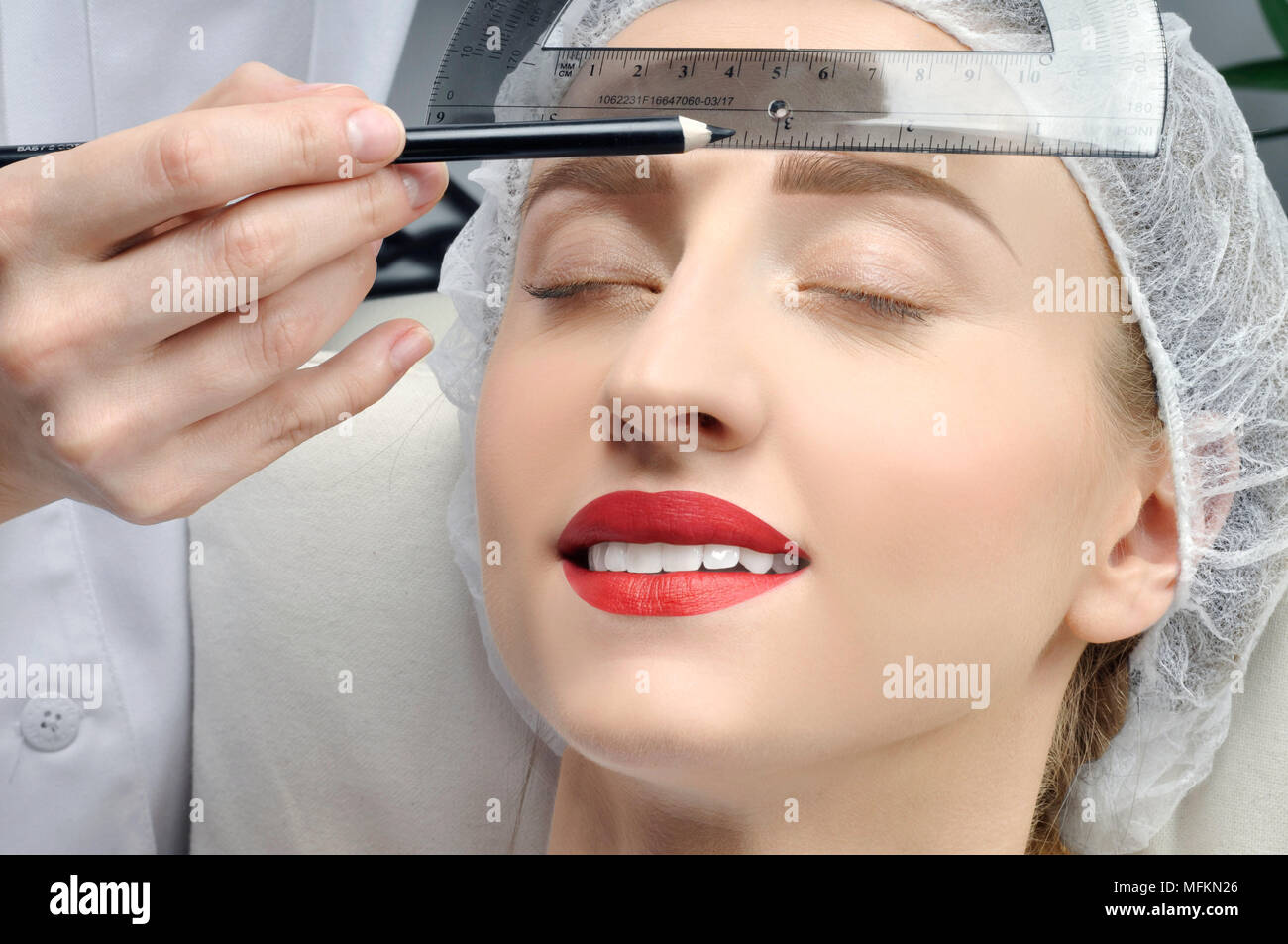 Microblading. Cosmetologist making permanent makeup. Woman getting