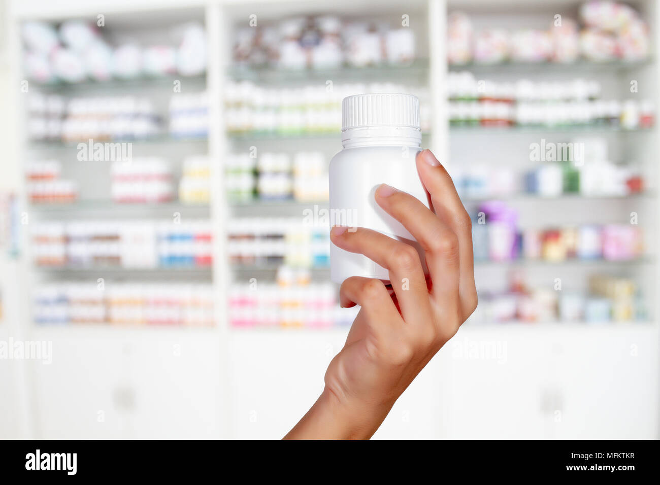 hand of doctor holding medicine bottle on medicine and store