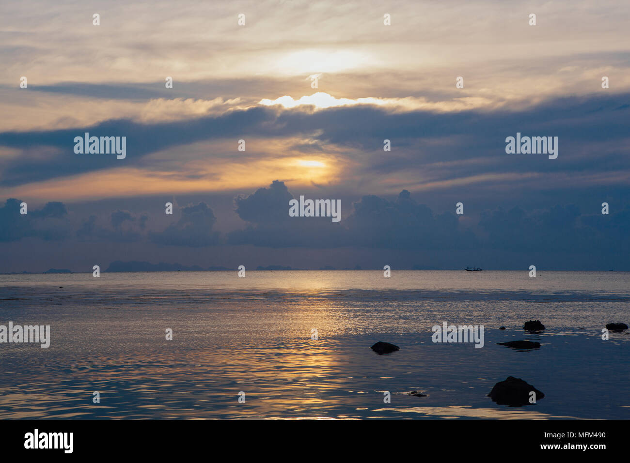 Amazing cloudy sunset on the tropical island Stock Photo - Alamy