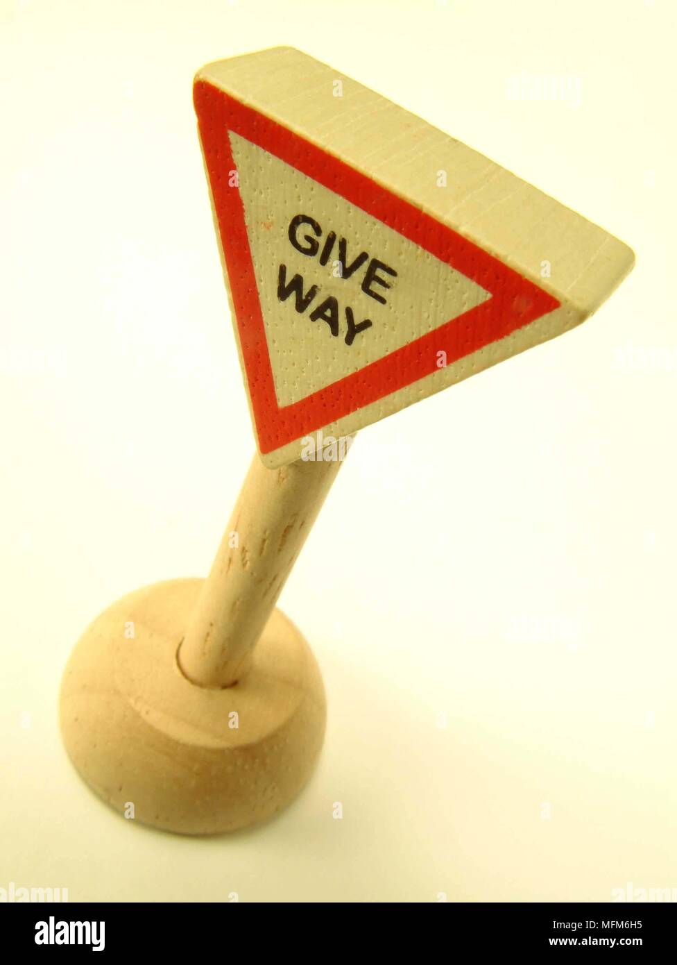 A high dramatic side view of a simple wooden toy road sign instructing