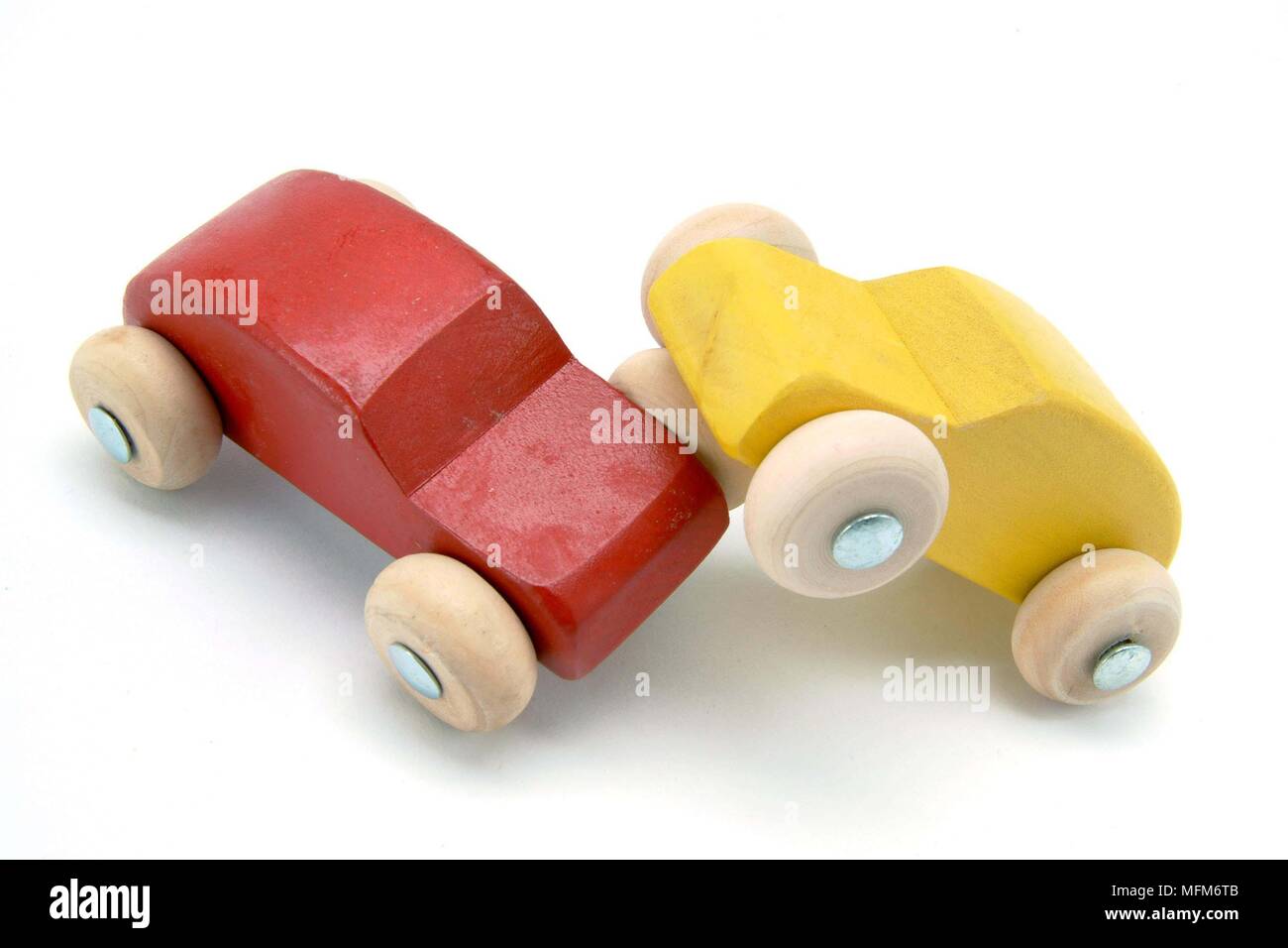 Two small wooden toy cars red and yellow, have had a head-on crash. Illustrating a traffic accident.    Bandphoto / COMPULSORY CREDIT: Hotshoe/Photosh Stock Photo