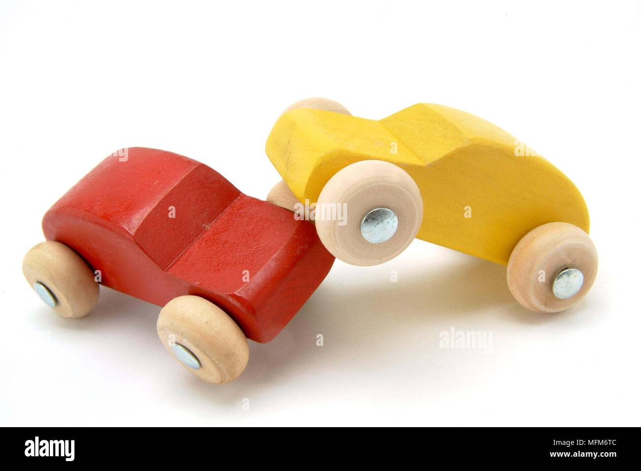 Two small wooden toy cars red and yellow, have had a head-on crash. Illustrating a traffic accident.    Bandphoto / COMPULSORY CREDIT: Hotshoe/Photosh Stock Photo