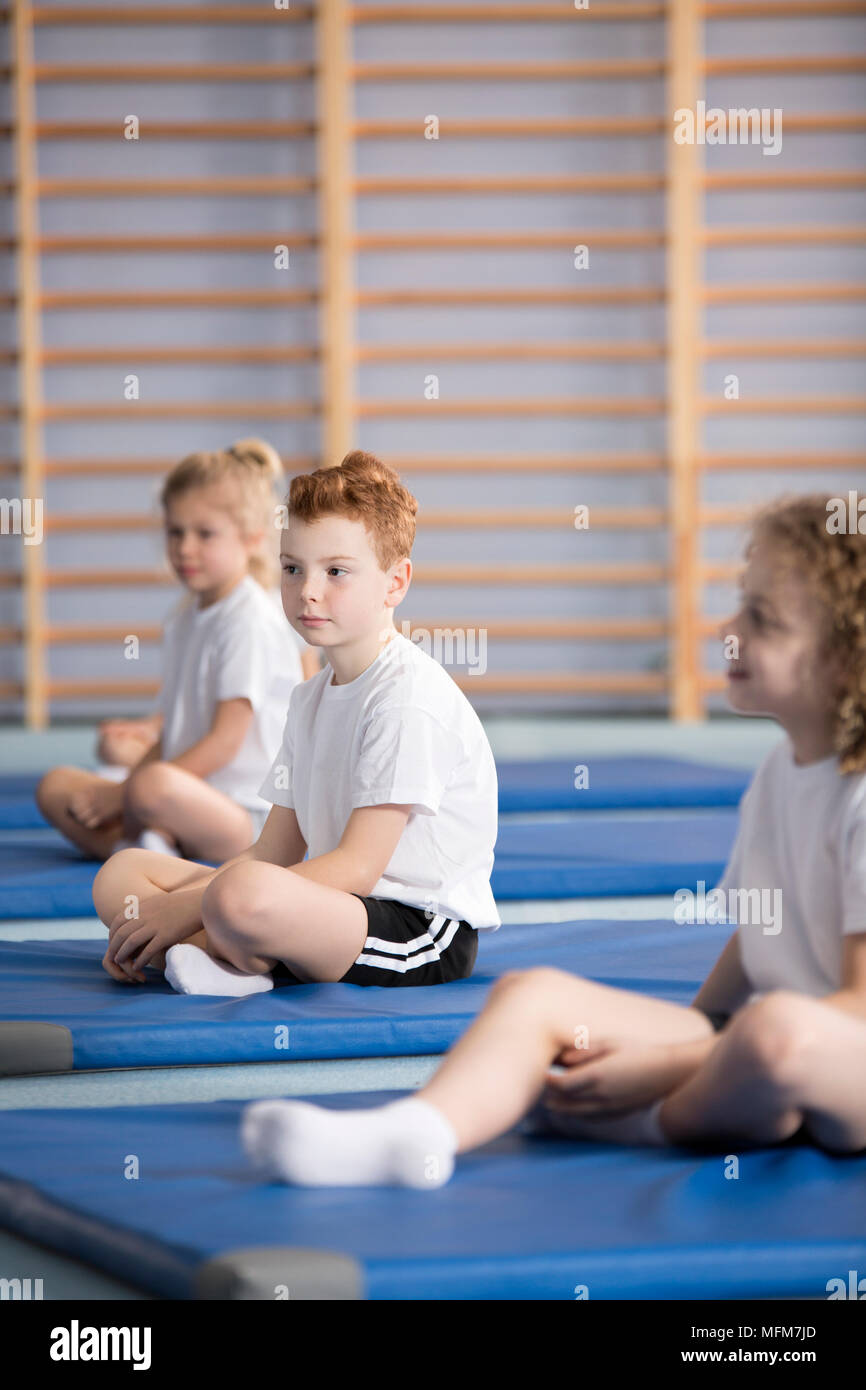 Side view of pupils in sportswear during training at the school gym Stock Photo