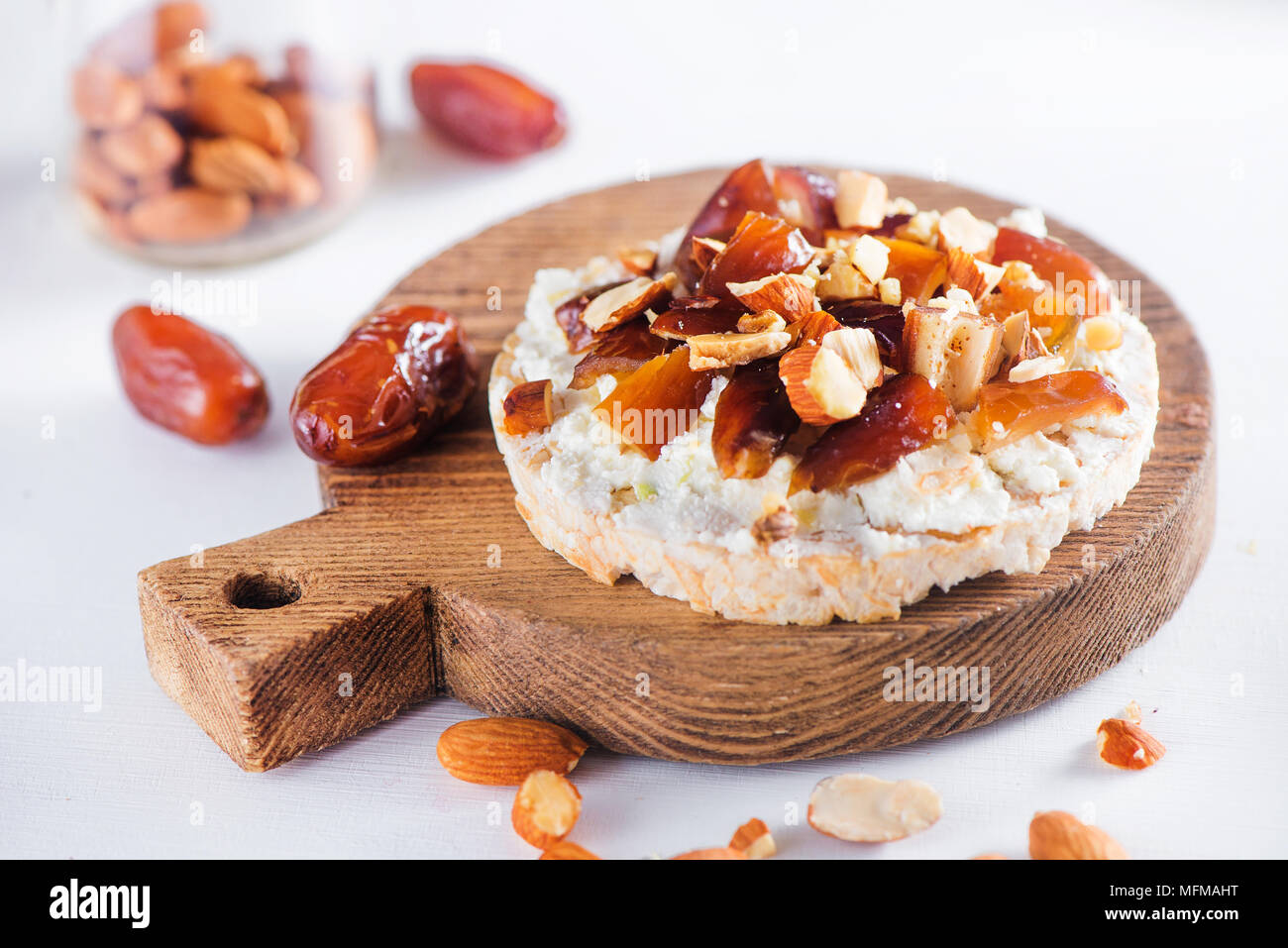 Healthy snack with crisp bread, dates, soft creme cheese, almond and