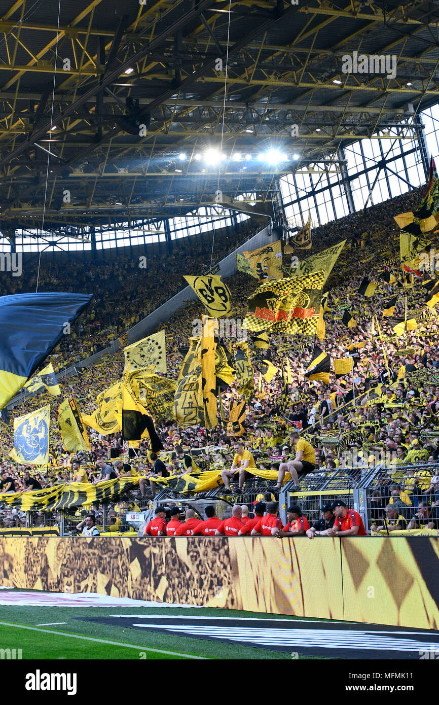 Supporters of Borussia Dortmund with flags on the south terrace of the Signal Iduna Park. Stock Photo