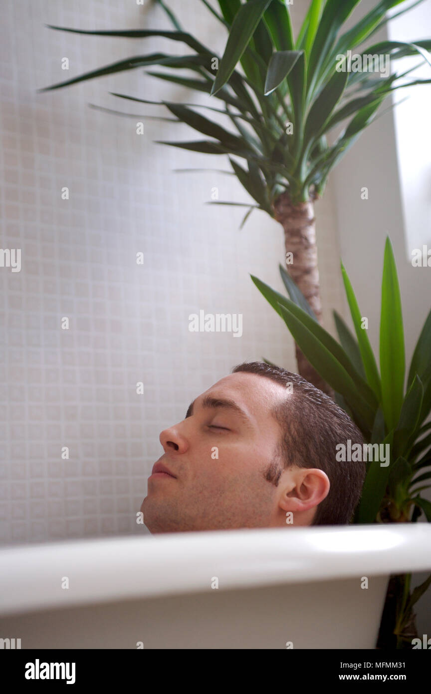 Closeup of a young man sleeping in a bathtub Ref CRB412 10004 090
