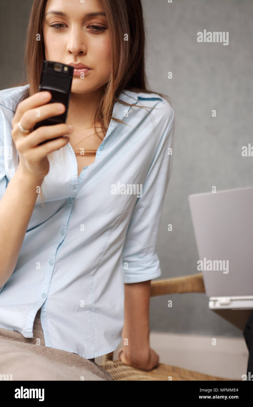 Using Phone Ref Perspective Close-up of a young woman using a mobile phone Ref: CRB413 10005 199 ...