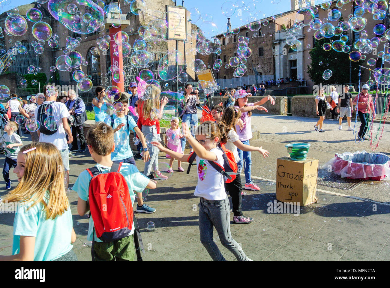 Street performance, A busker blowing giant soap bubbles with loops ...