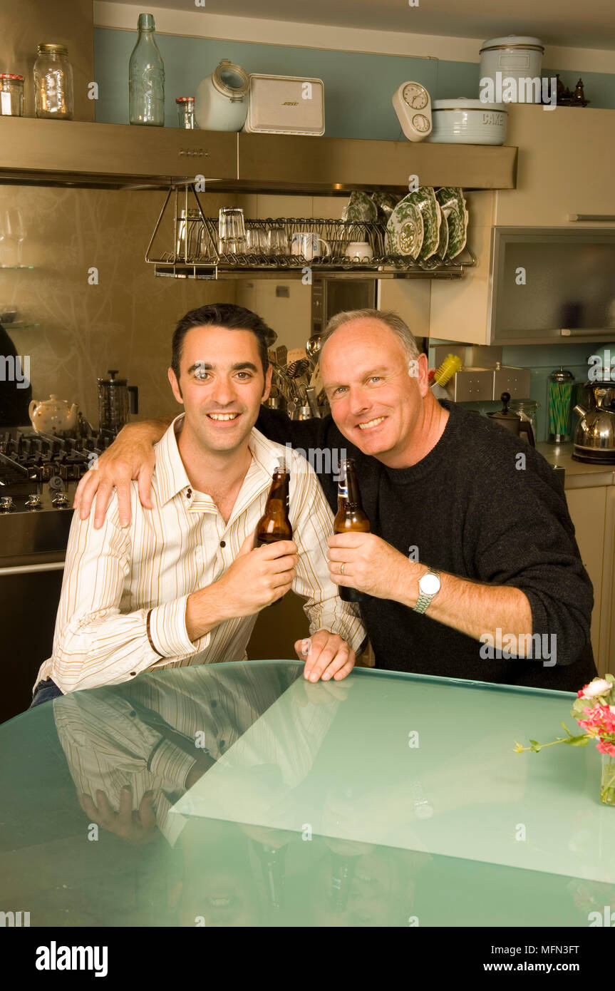 Two men holding up bottles hi-res stock photography and images - Alamy