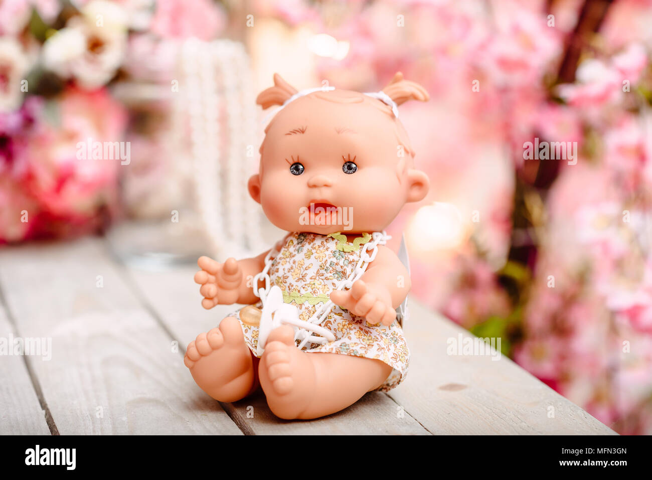 Beautiful girl, doll with flowers, floral wreath, bouquet, tied bows, butterly and sparkles. Stock Photo