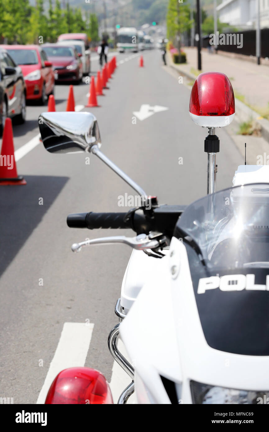 Japanese police motorcycle with red lamp on the road Stock Photo