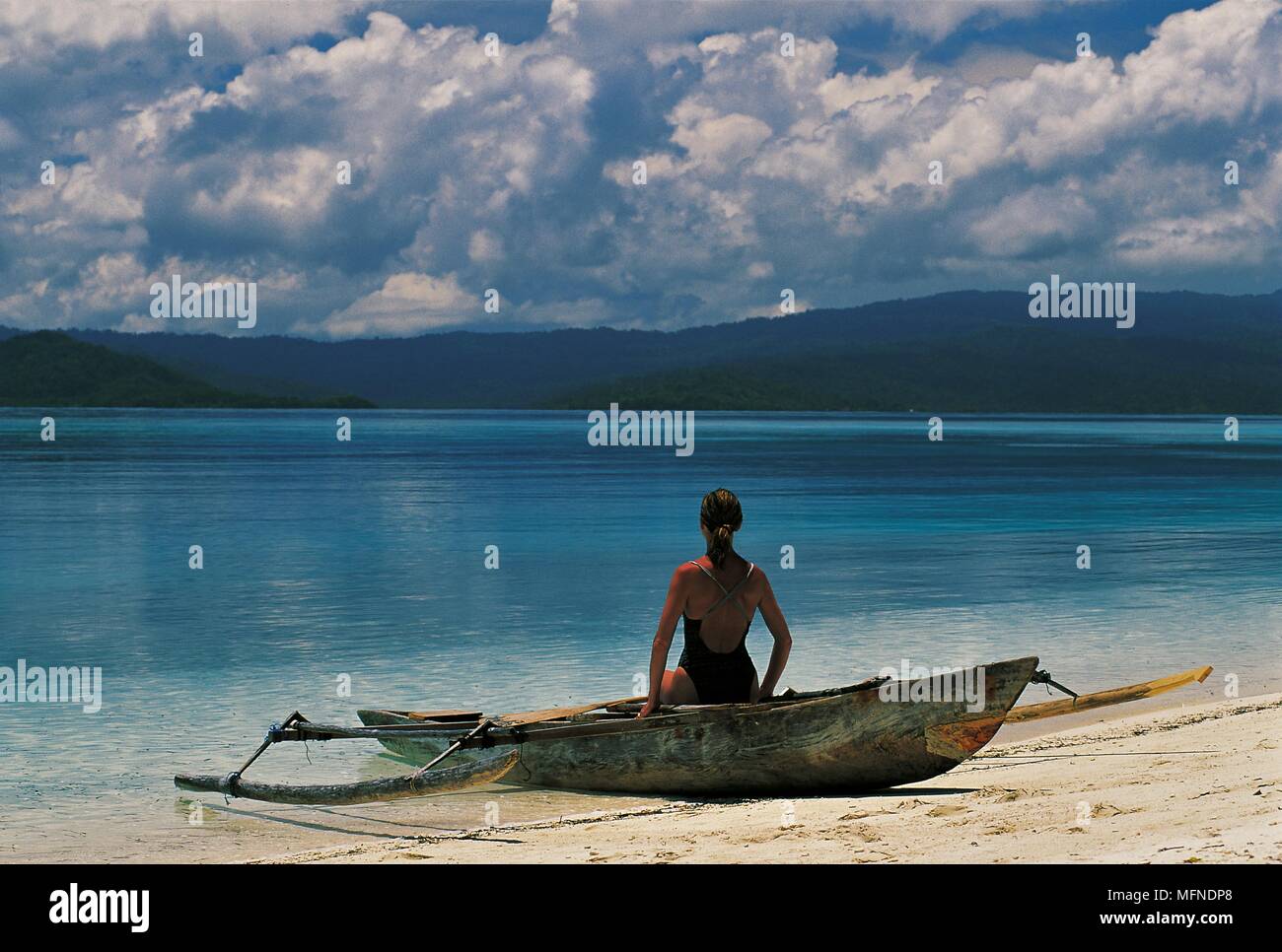Tourist on Wai Island beach, Raja Ampat, West Papua, Indonesia   Date: 19.07.2006   Ref: B377 095549 0017  COMPULSORY CREDIT:  Andrea & Antonella Ferr Stock Photo
