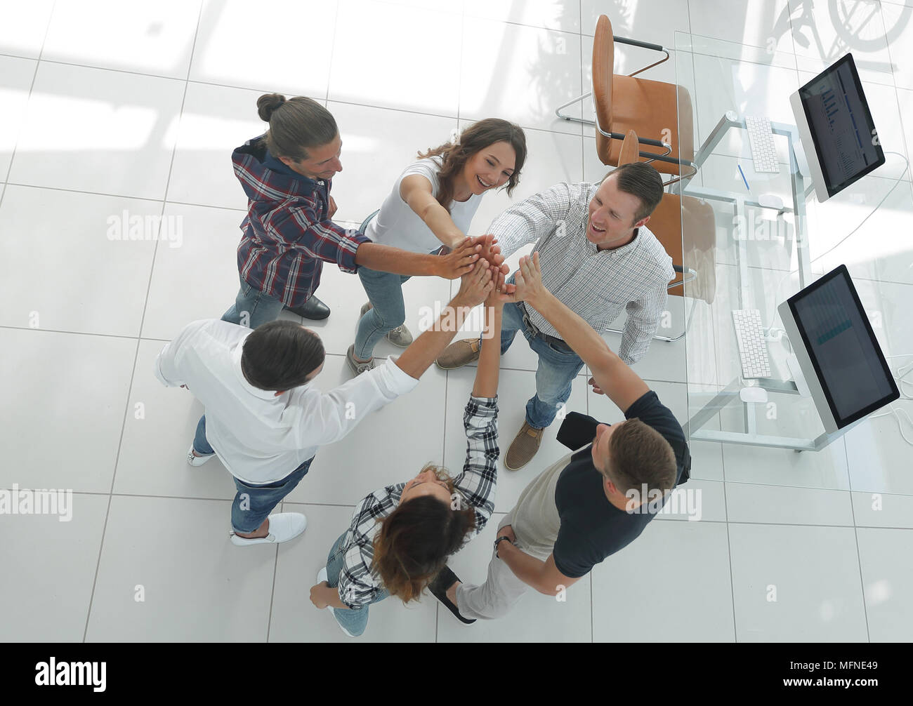 creative team giving each other a high five Stock Photo - Alamy