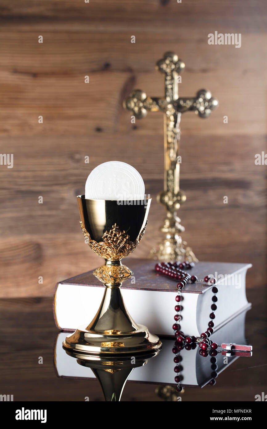 First holy communion theme. The Cross, Holy Bible, rosary and golden  chalice on brown background Stock Photo - Alamy