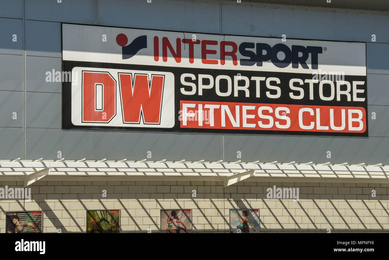 Large sign above the entrance to a DW Sports store and fitness club on a retail park Stock Photo