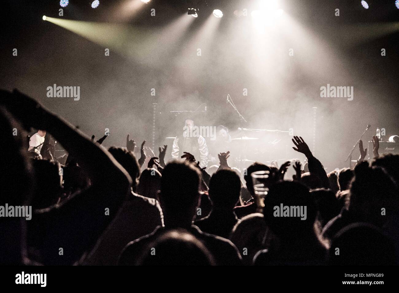 People having fun at a concert, looking to the stage, hands in the air, music has been gone for a long time, getting back to shows, gigs, live events Stock Photo