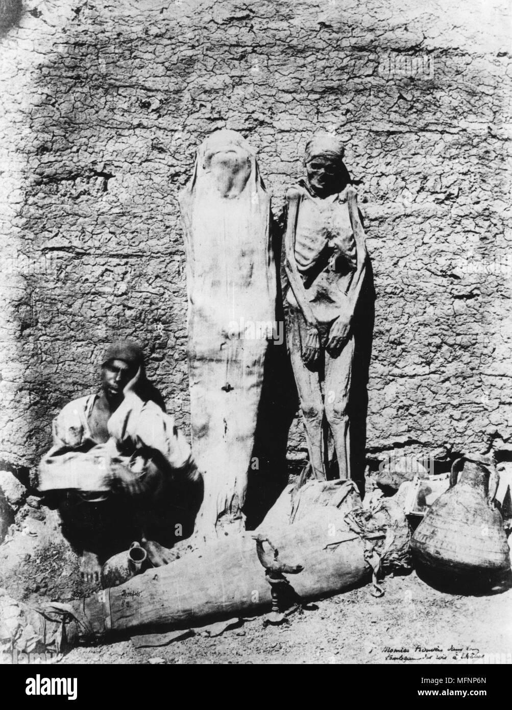 Ancient Egyptian mummies, 1860. Mummies displayed outside a tomb at Thebes. Bibliotheque Nationale, Paris. Photograph Stock Photo