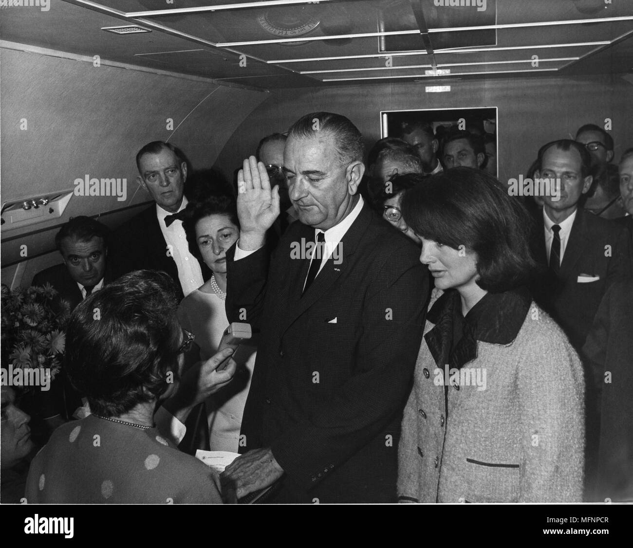 Swearing in of Lyndon Baines Johnson (1908-1973) as 36th President of the United States, 22 November 1963. The ceremony took place on Air Force One, Love Field, Dallas, Texas.  At his side is Jackie Kennedy, widow of the assassinated president, John F Kennedy. LBJ Library, photo by Cecil Stoughton. Stock Photo