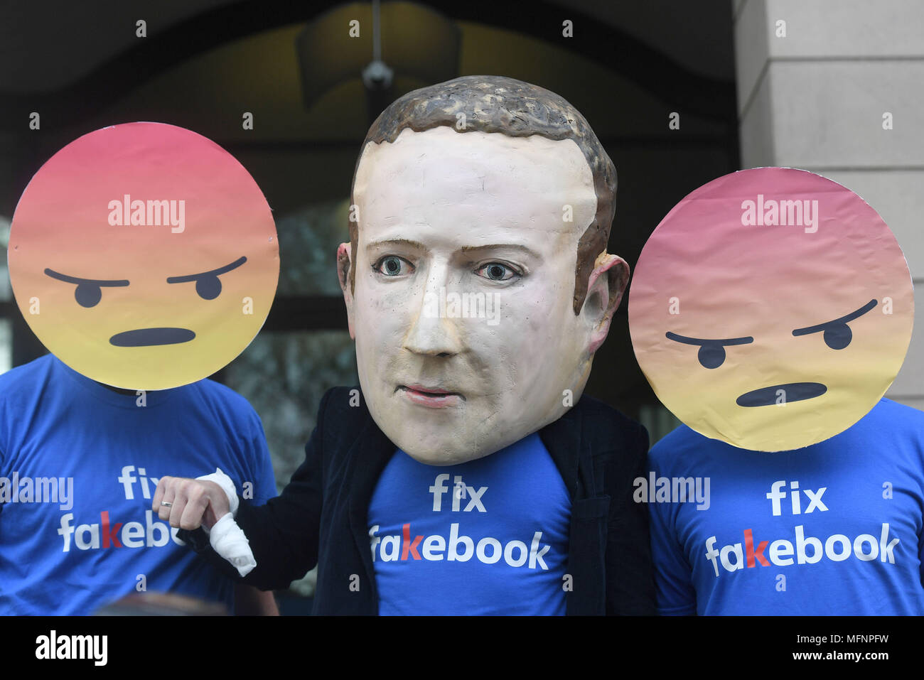 A Mark Zuckerberg figure with people in angry emoji masks outside Portcullis House in Westminster, London ahead of Mike Schroepfer, Chief Technology Officer at Facebook, appearing before the DCMS inquiry into fake news. Stock Photo