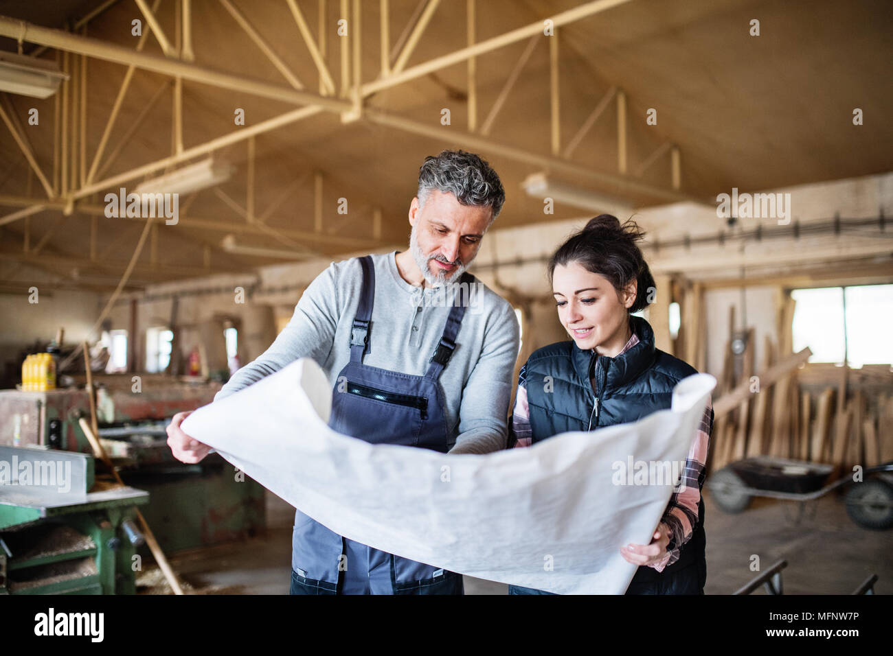 Man and woman workers in the carpentry workshop Stock Photo - Alamy