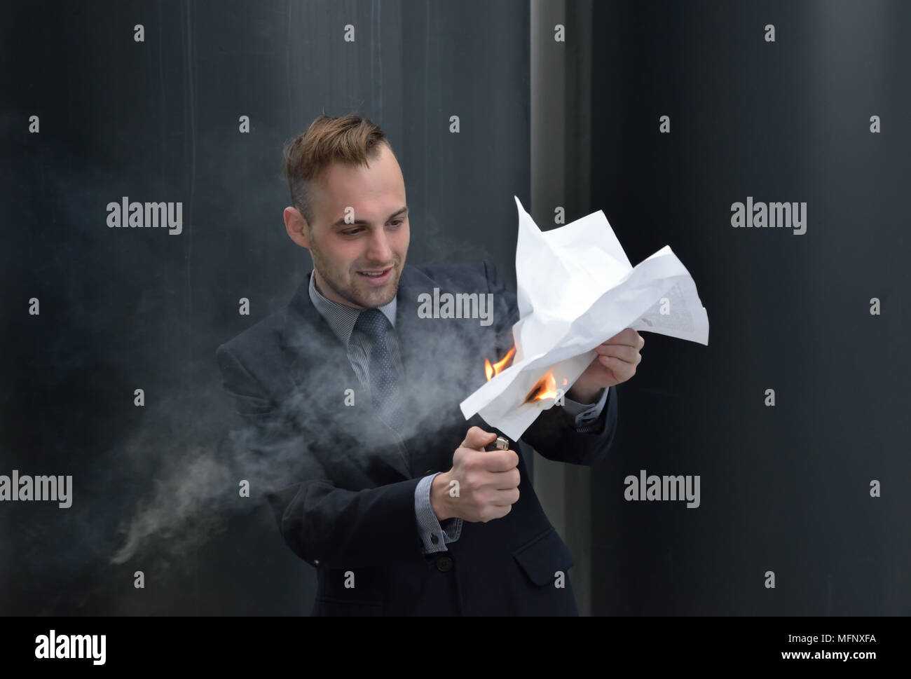 businessman burns paper contract Stock Photo
