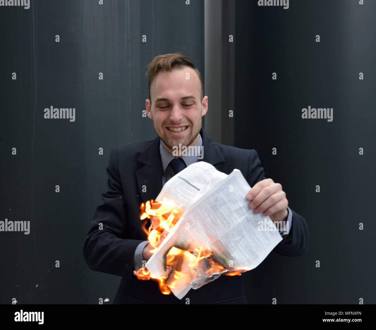 businessman burns paper contract Stock Photo