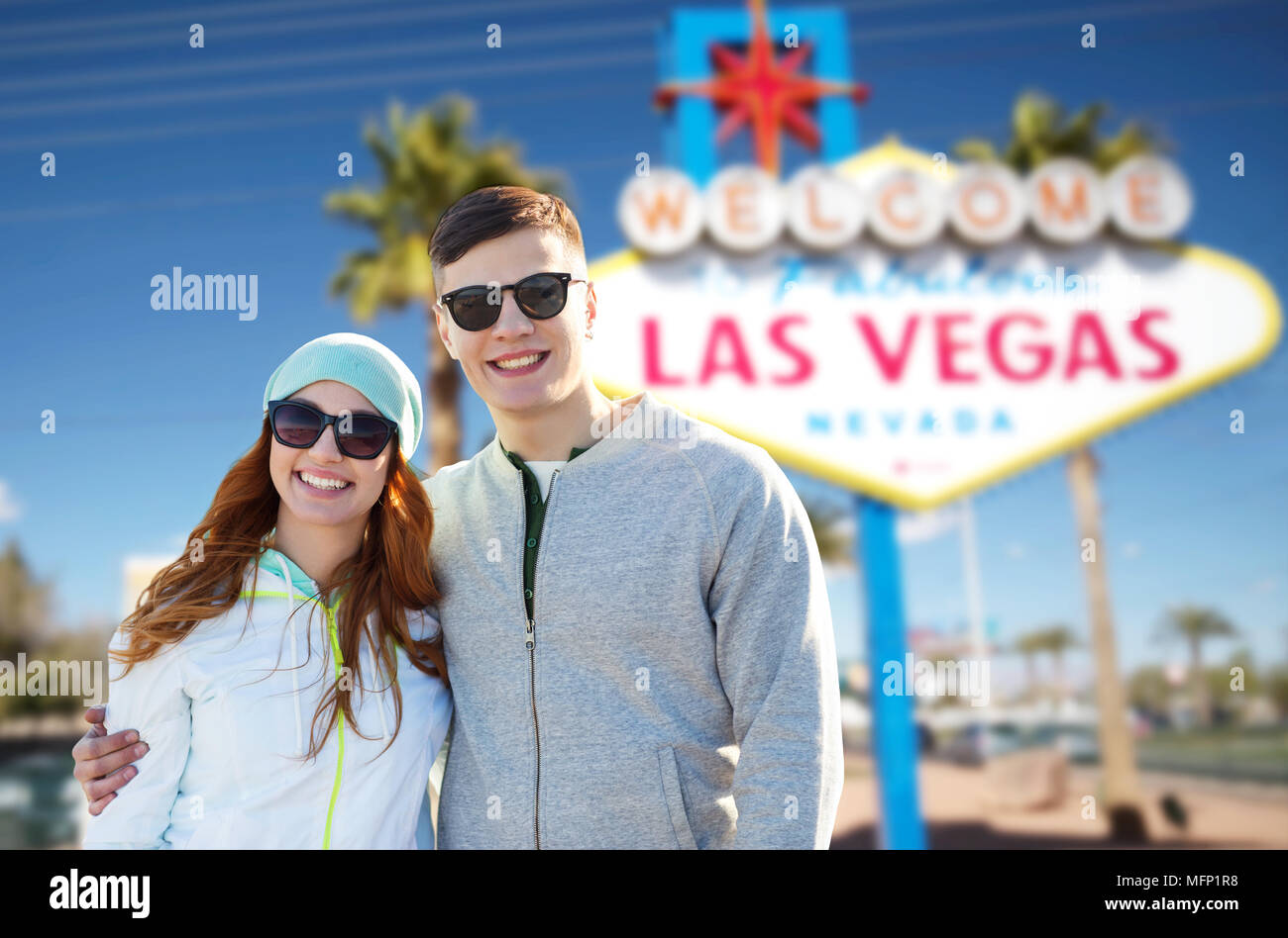 teenage couple in shades over las vegas sign Stock Photo Alamy