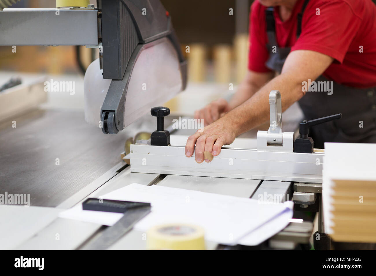 carpenter with panel saw and fibreboard at factory Stock Photo