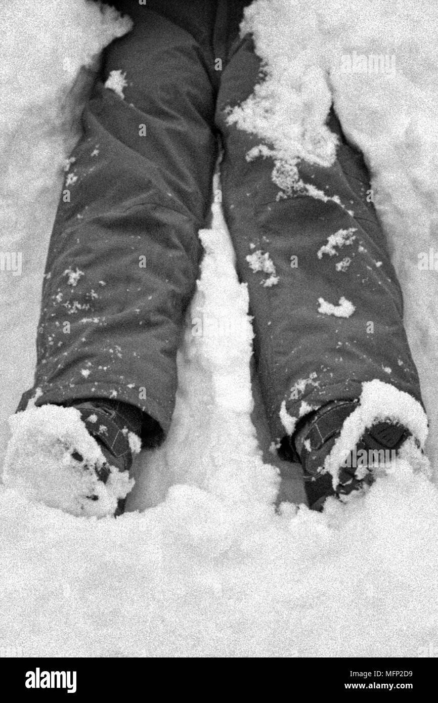 Legs of a child in the snow Stock Photo