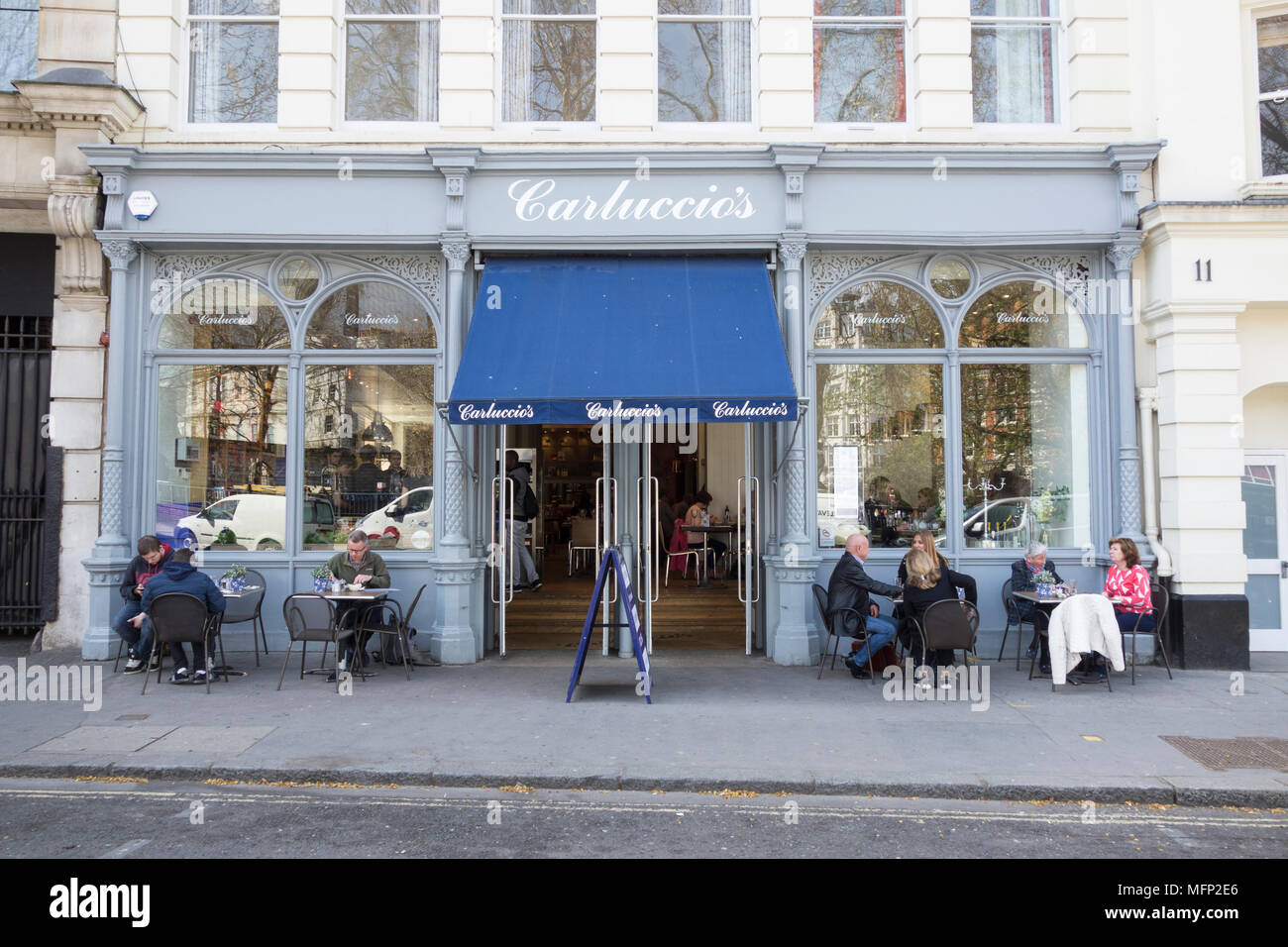 People eating outside Carluccio's Italian restaurant, West Smithfield, London, EC1, UK Stock Photo